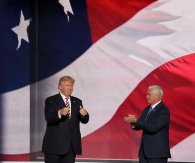 Donald Trump beside man in black suit