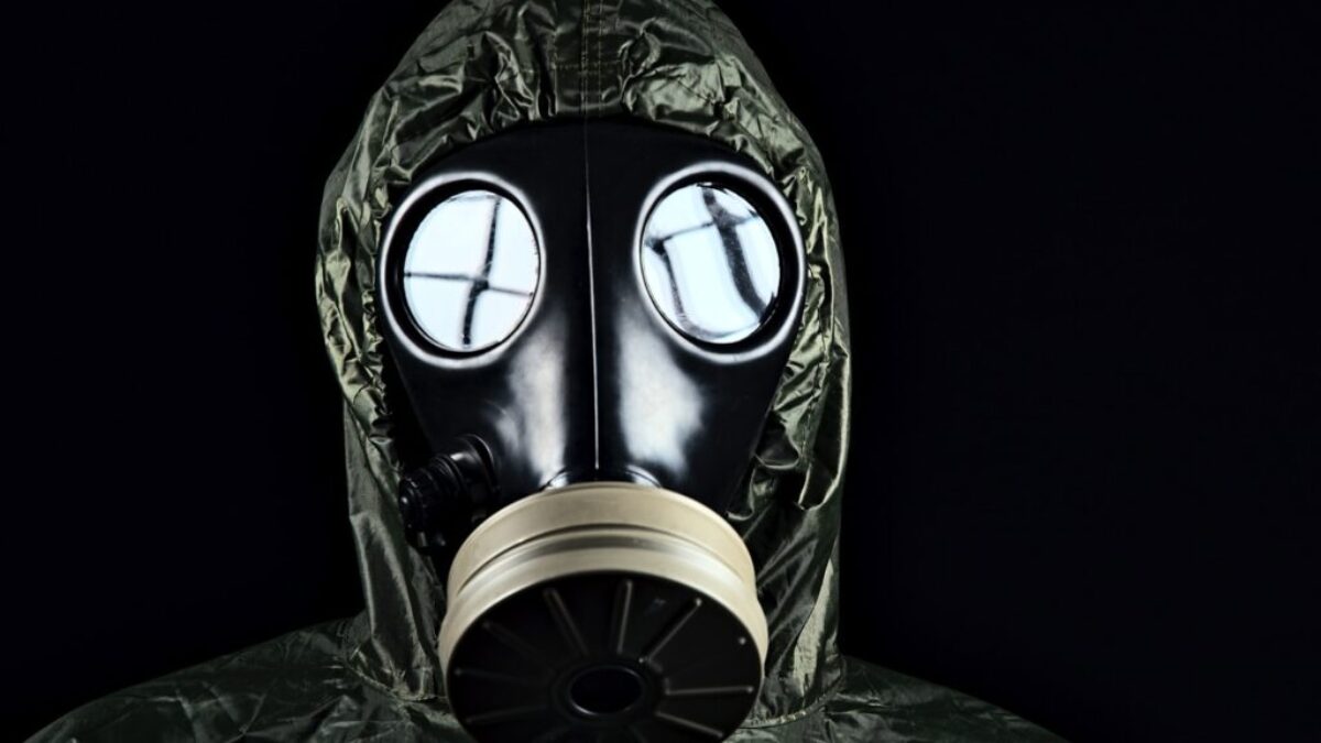person in green and black gas mask