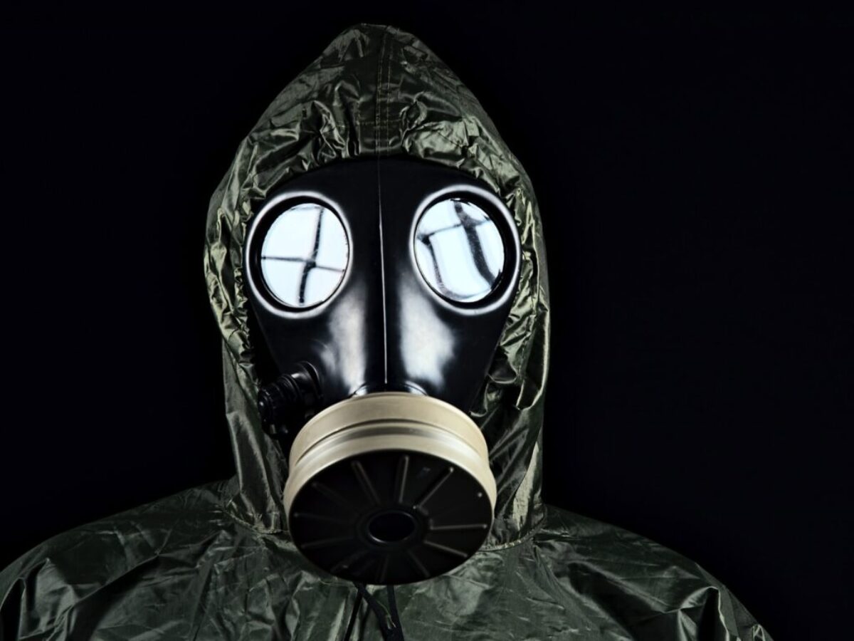 person in green and black gas mask