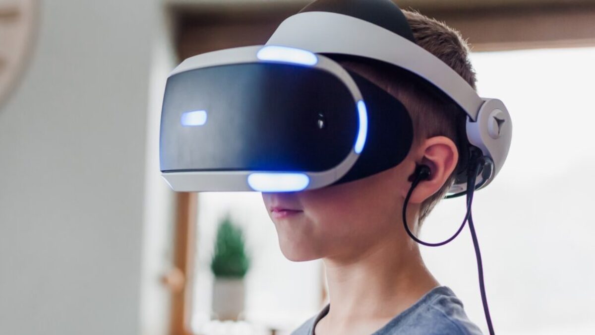 boy wearing black and white VR headset