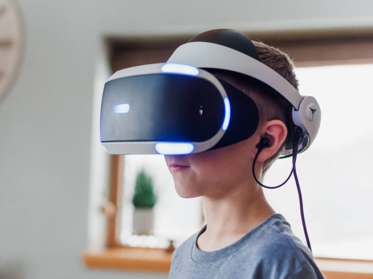 boy wearing black and white VR headset