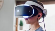 boy wearing black and white VR headset
