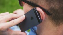 person holding black iPhone 5s