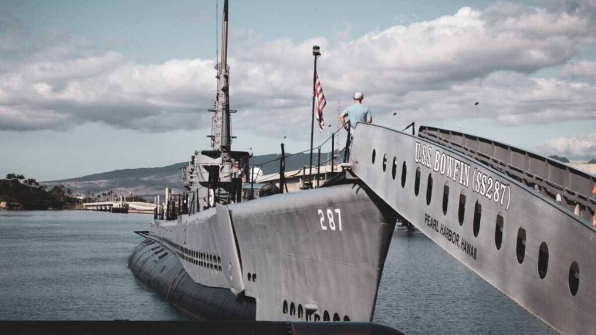 grey warship on dock during daytime