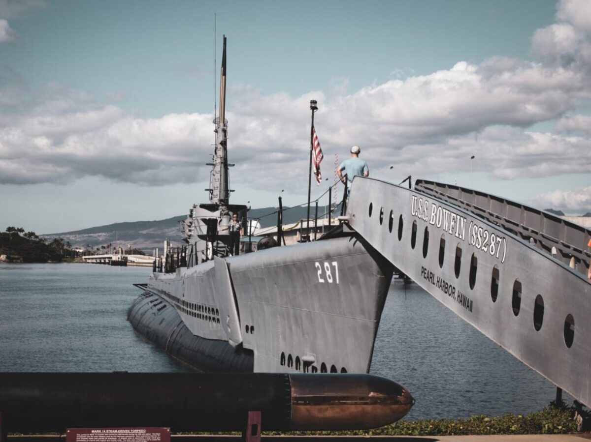 grey warship on dock during daytime