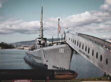 grey warship on dock during daytime