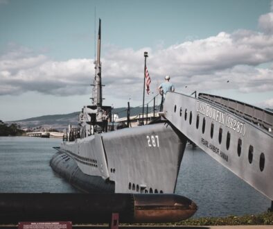 grey warship on dock during daytime
