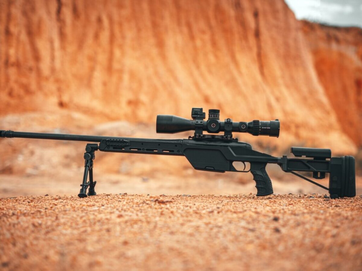 black rifle on brown sand