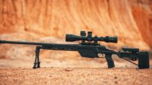 black rifle on brown sand
