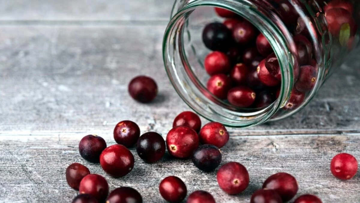 red round fruits in clear glass jar