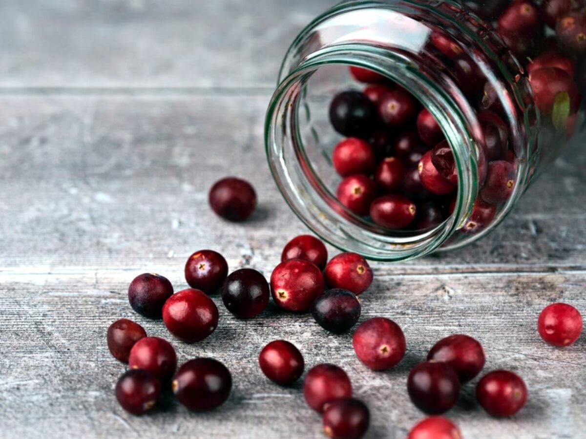 red round fruits in clear glass jar