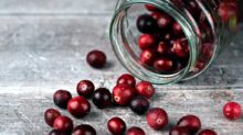 red round fruits in clear glass jar