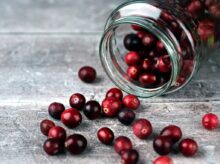 red round fruits in clear glass jar