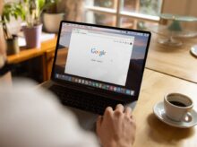 person using macbook pro on table