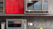 silver microwave oven on black marble counter top