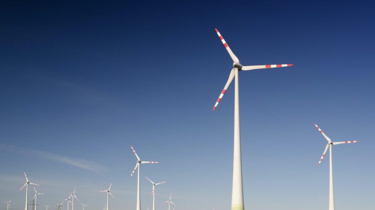 windmills on grass field at daytime
