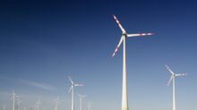 windmills on grass field at daytime