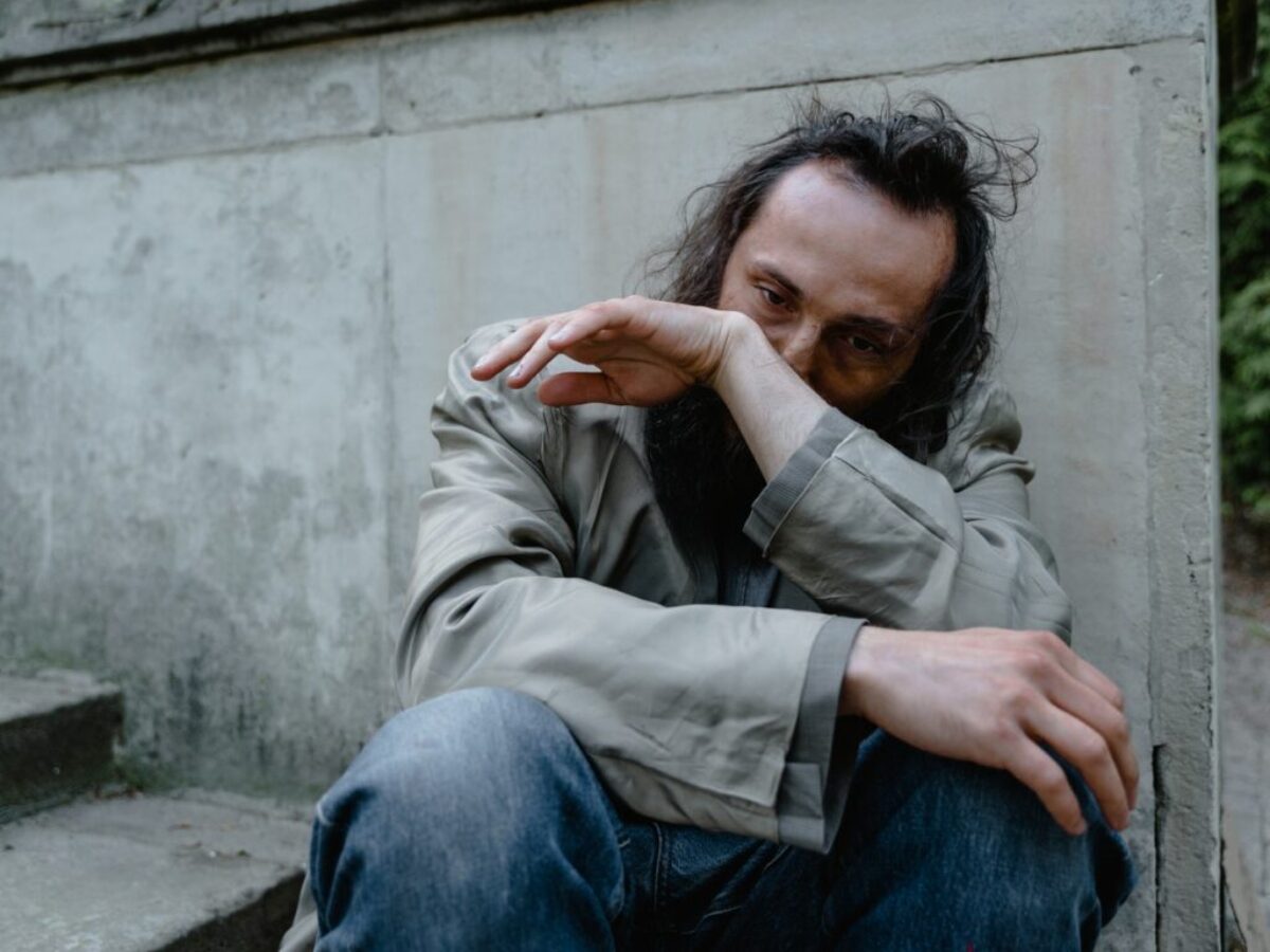 Lonely Man Sitting on a Concrete Stairs