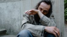 Lonely Man Sitting on a Concrete Stairs