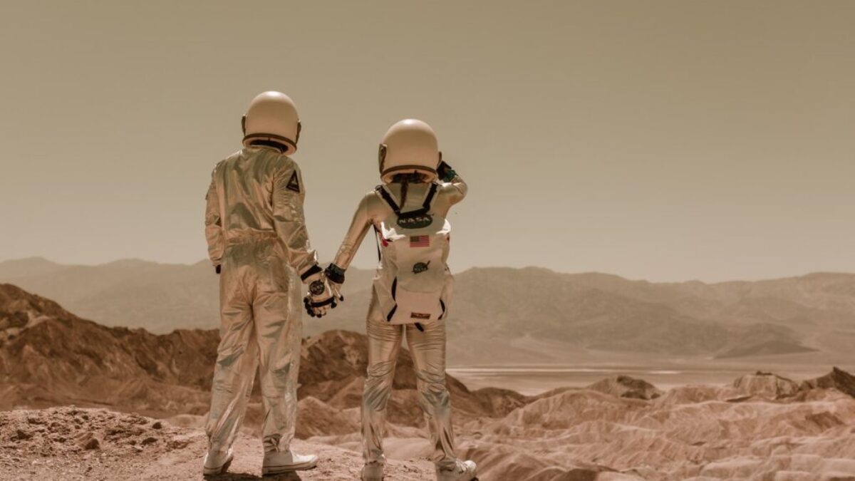 Back View of Astronauts Holding Hands