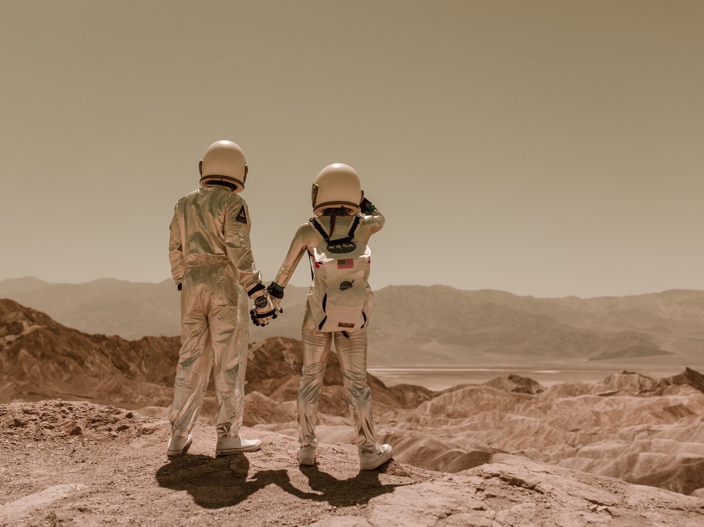 Back View of Astronauts Holding Hands