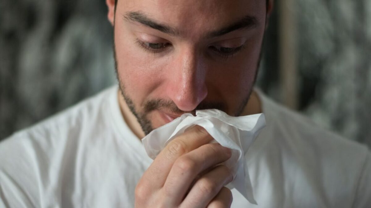 man wiping mouse with tissue paper