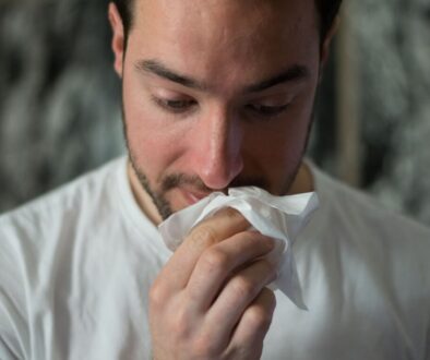man wiping mouse with tissue paper