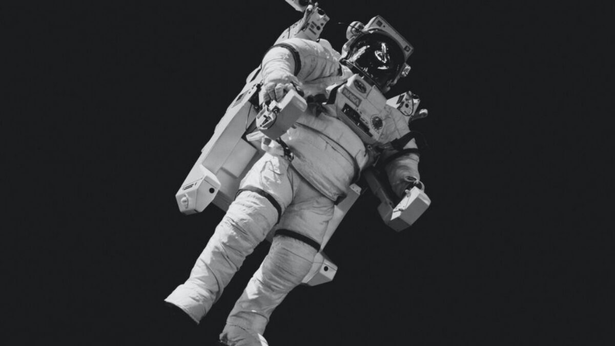 astronaut in white suit in grayscale photography