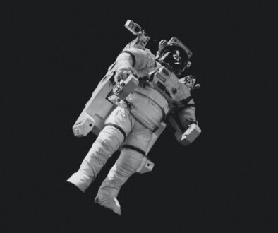 astronaut in white suit in grayscale photography