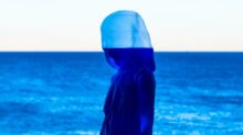 painting of woman and calm ocean