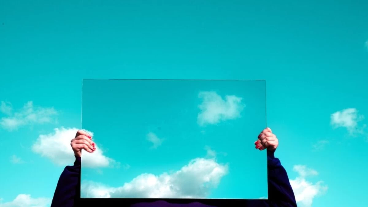 man in black suit jacket raising his right hand