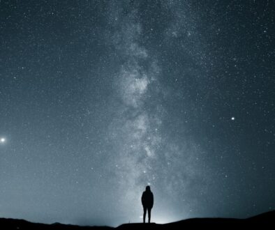 silhouette of person under starry sky
