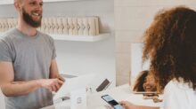 man in grey crew-neck t-shirt smiling to woman on counter