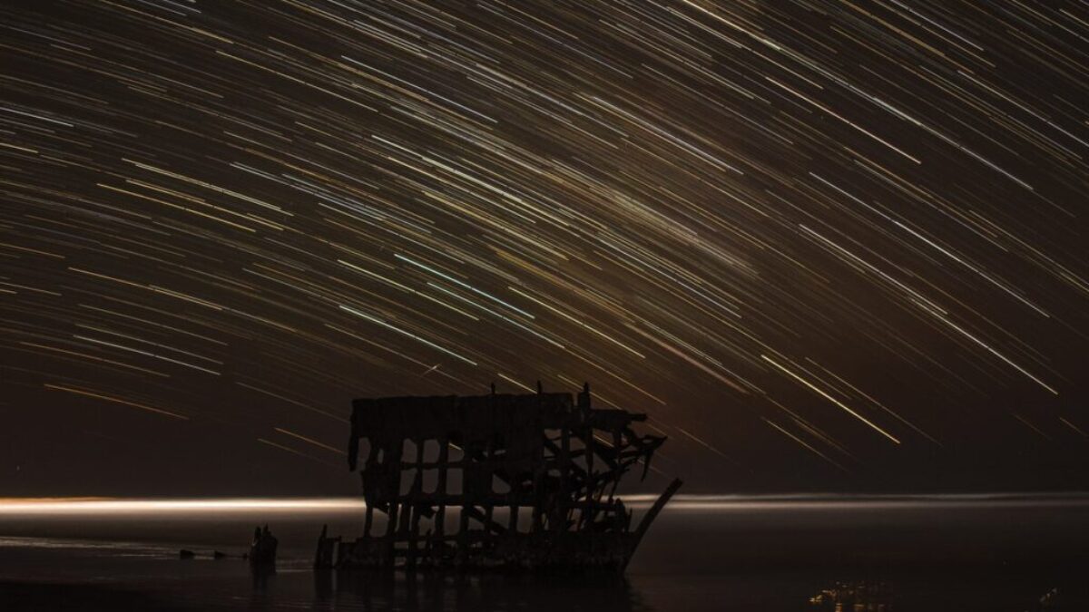 time lapse photography of house with shooting star at night time
