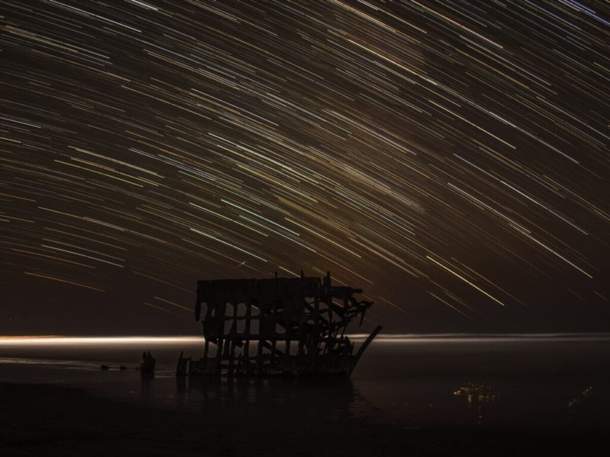 time lapse photography of house with shooting star at night time