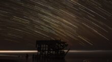 time lapse photography of house with shooting star at night time