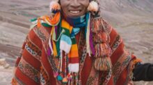 smiling man standing in front of mountains during day