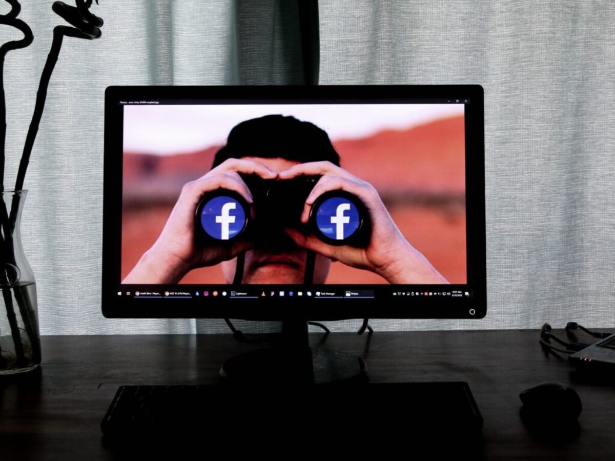 television showing man using binoculars