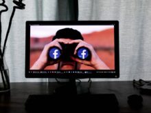 television showing man using binoculars