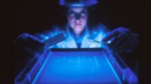woman doing research while holding equipment
