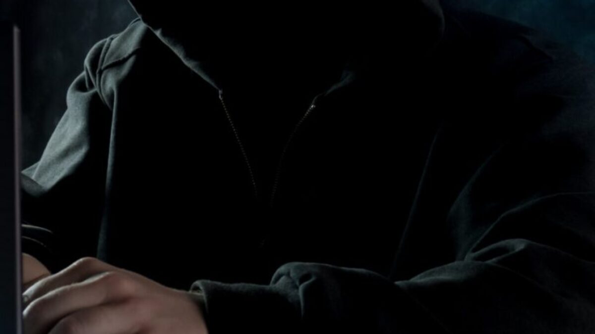 person in black hoodie using laptop computer