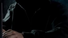 person in black hoodie using laptop computer