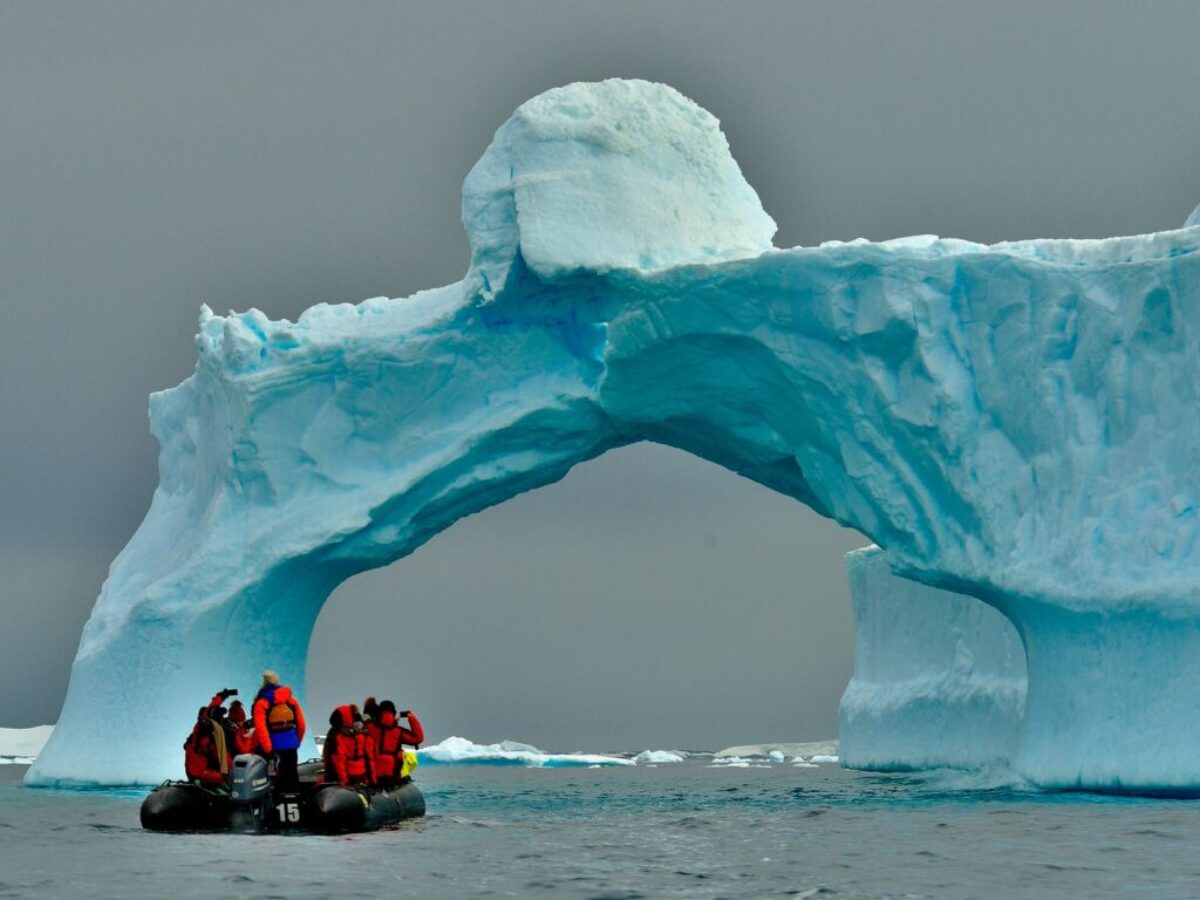 people sitting on ice formation during daytime