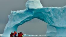 people sitting on ice formation during daytime