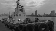 grayscale photo of a boat on a body of water
