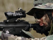 man in woodland camouflage uniform using sniper rifle