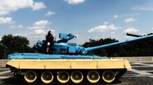 person sitting on tank