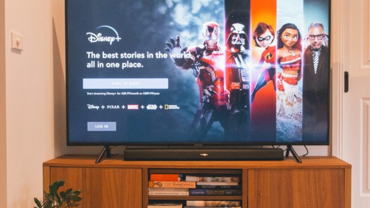 black flat screen tv turned on on brown wooden tv rack