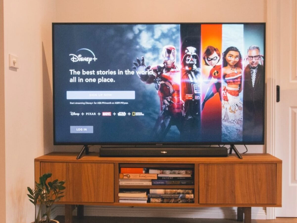 black flat screen tv turned on on brown wooden tv rack