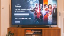black flat screen tv turned on on brown wooden tv rack